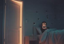 Why People Hide Their Real Desires from Partners A bedroom at 2 AM with a person looking at a phone in bed.